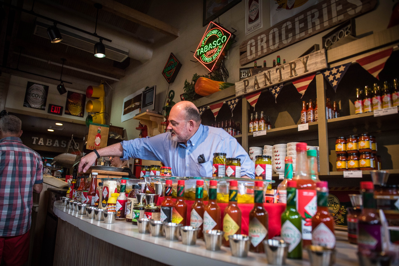 Osborn hops behind the counter at the Avery Island Tabasco shop to show off his favorite products.